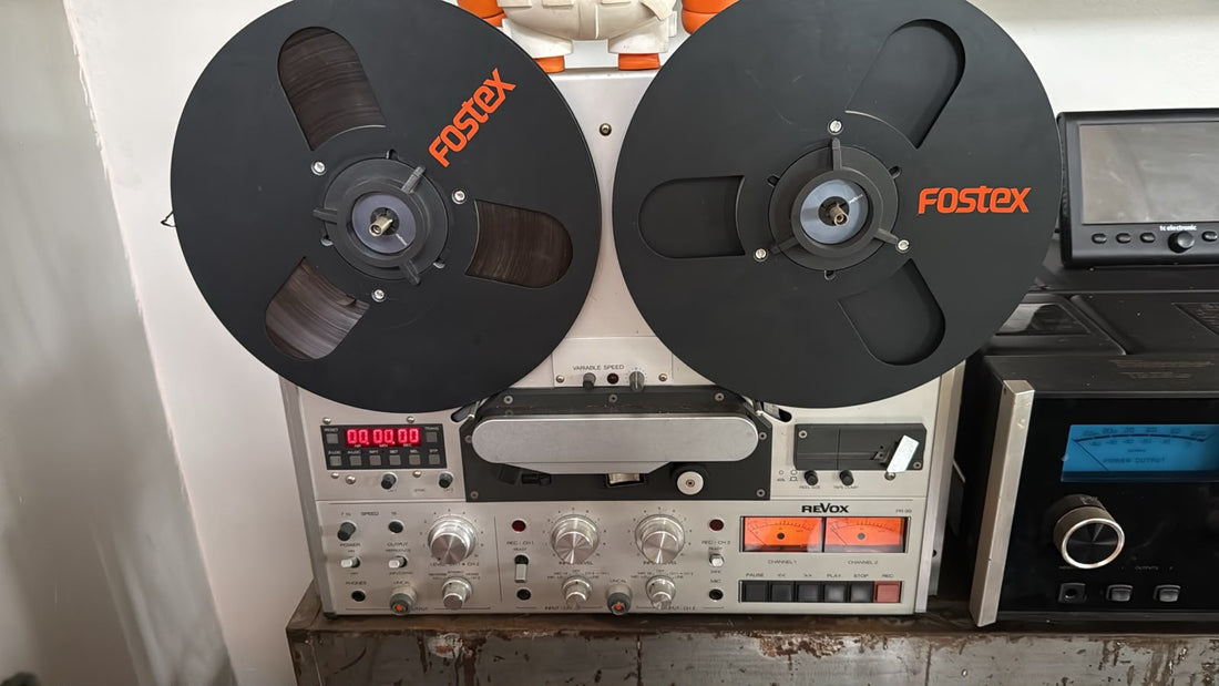 A Revox PR-99 quarter inch reel to reel tape machine, heads and transport visible