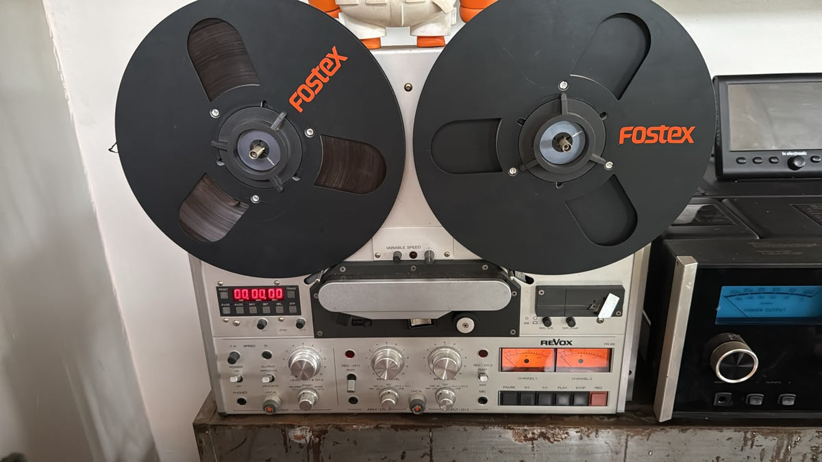 A Revox PR-99 quarter inch reel to reel tape machine, heads and transport visible
