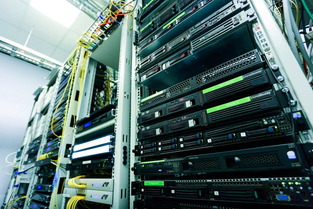 Four-post server cabinets in a data centre, square-hole mounting rails visible, the source of most cheap second-hand 19 inch racks