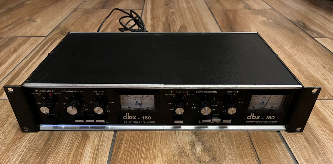 A dbx 160 VU compressor, the original half-rack model with wooden cheeks and a single VU meter